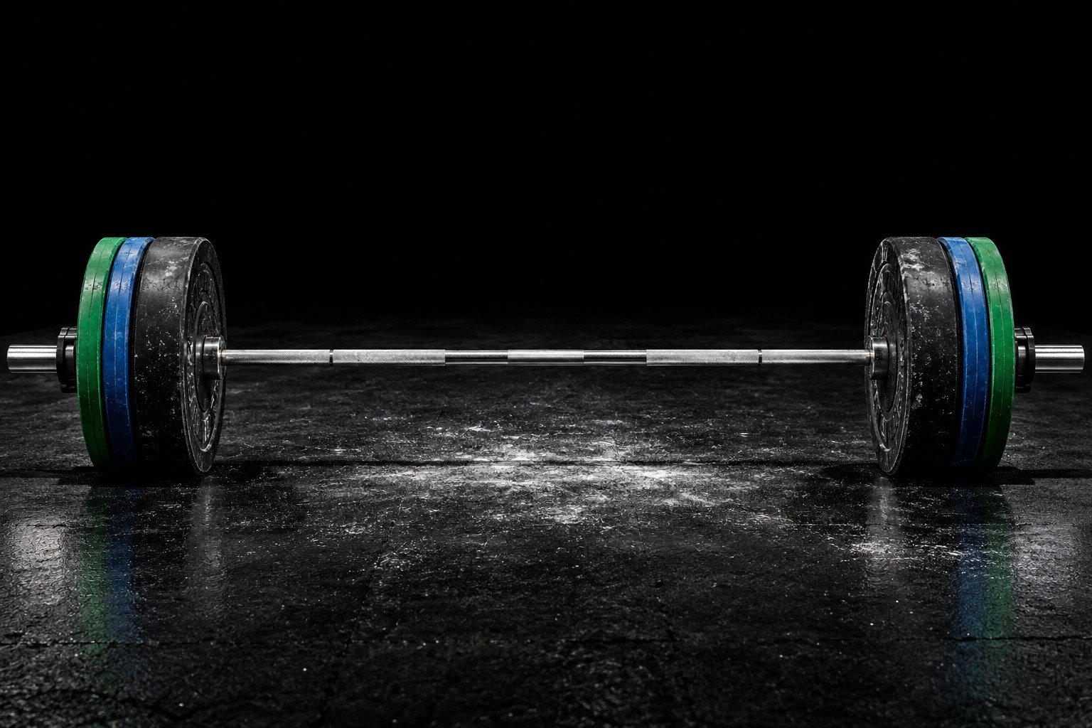 Steel, rubber and chalk in a dark weight room
